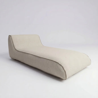 Beige lounge chair on a light gray background