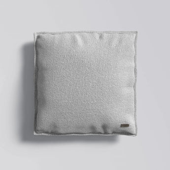 Gray textured pillow on a light gray background