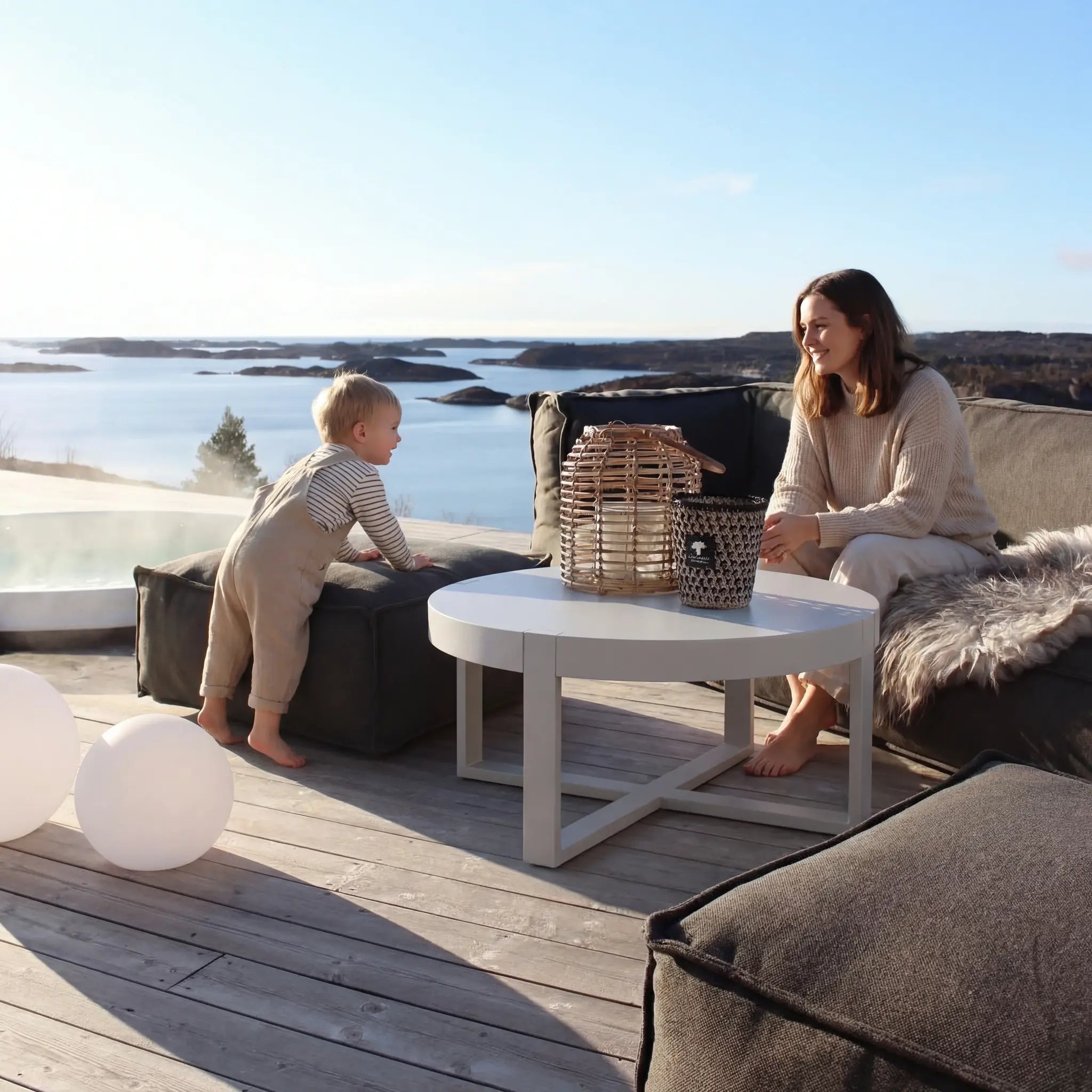 Family enjoying Troispommes outdoor furniture on wooden deck