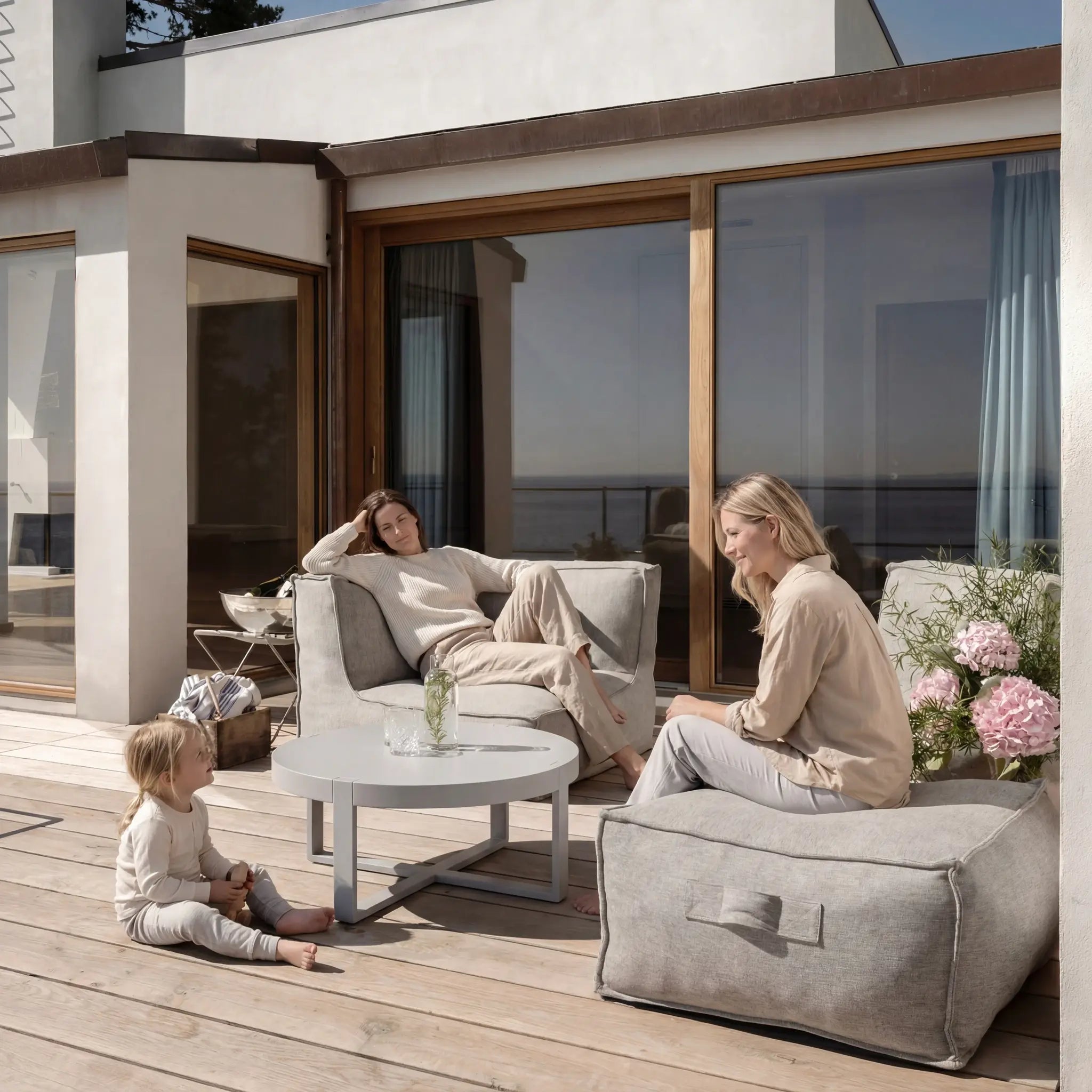 Family enjoying Troispommes outdoor furniture with scenic panoramic view